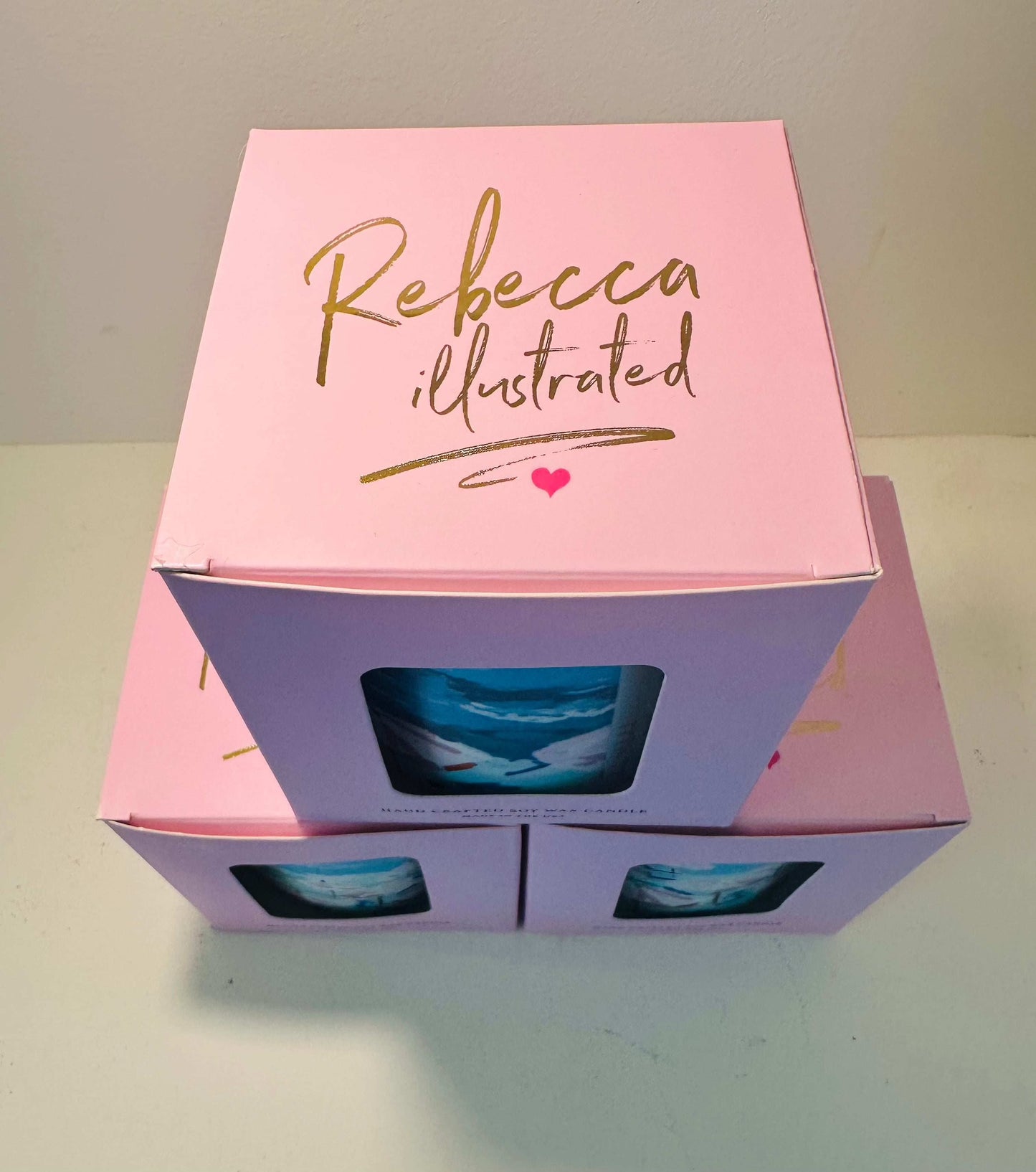 Rebecca Illustrated PALM TREE TOLIE candle packaging with pink box and exclusive artwork.