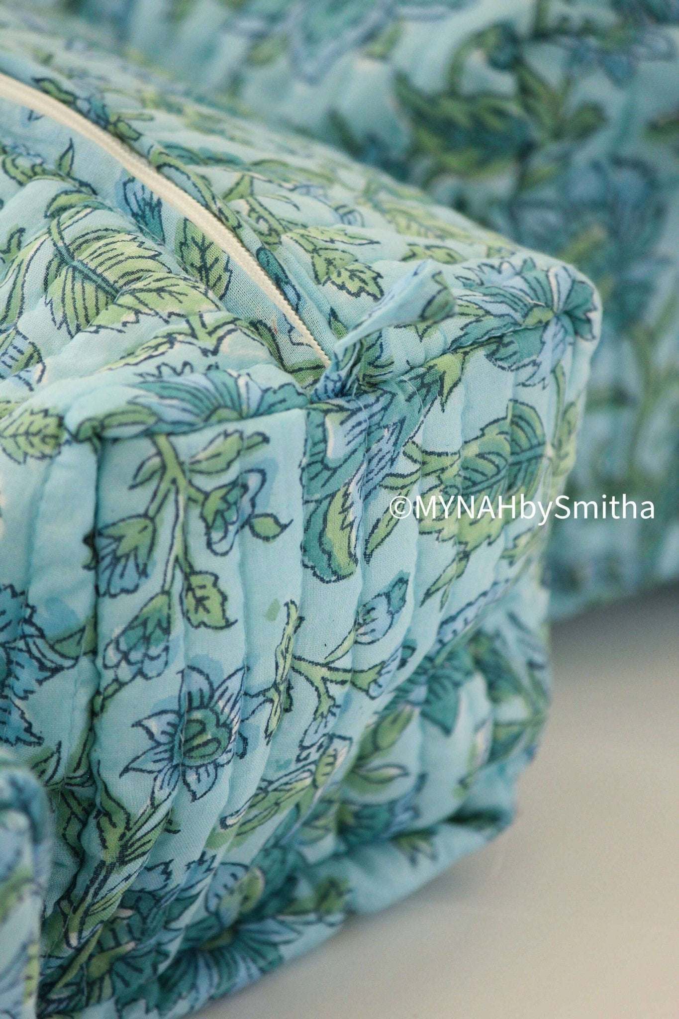 Blue green floral hand block printed travel makeup organizer bag.