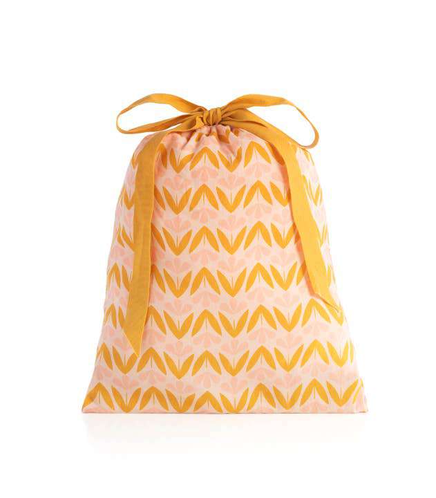 Blush Flora PJ Set in drawstring bag with floral pattern.
