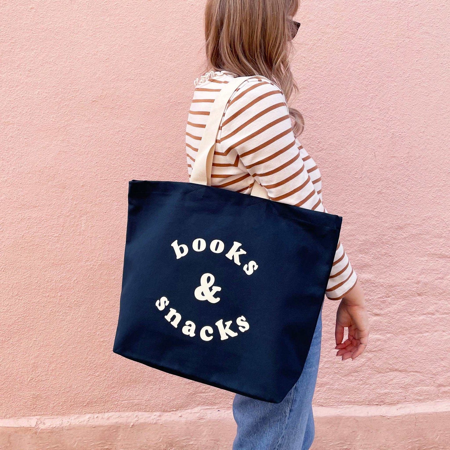 Midnight blue canvas tote bag with "Books & Snacks" design in off-white, perfect for daily essentials.