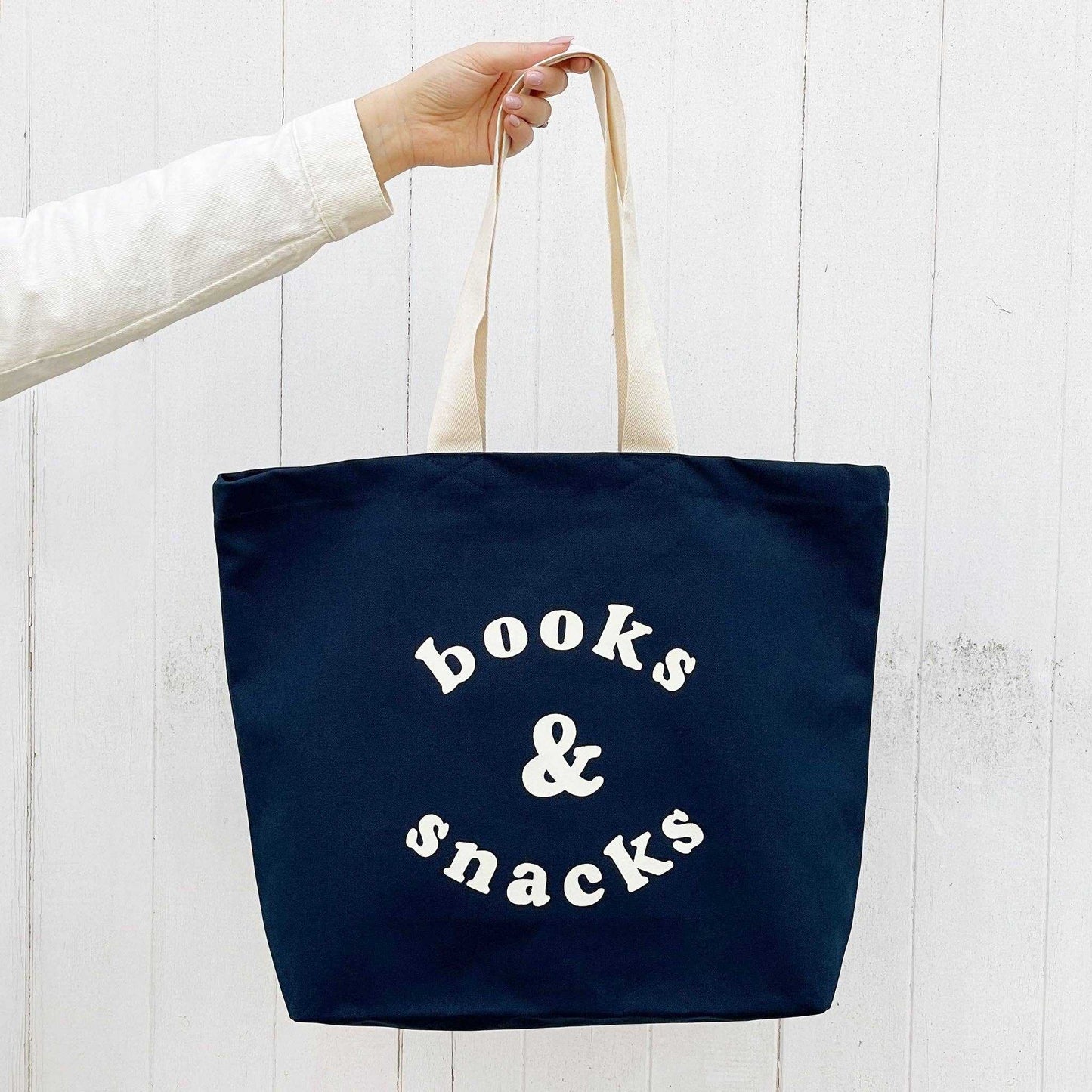 Midnight blue canvas tote bag with "Books & Snacks" design in off-white, large and spacious for daily essentials.
