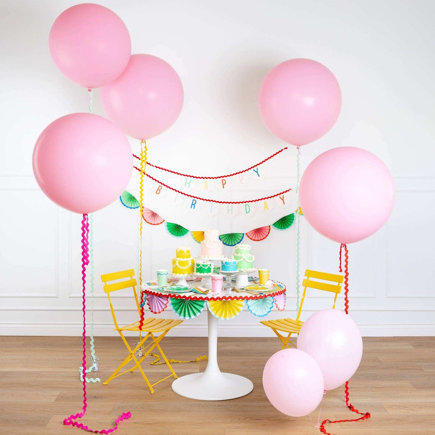 Bunting Banner with colorful accordion style paper fans for party decor.