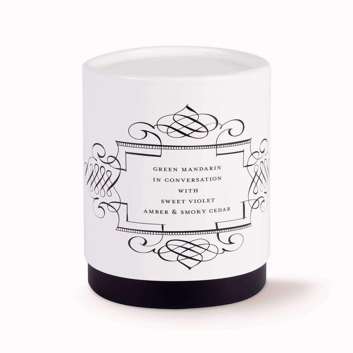 Calligraphy Candle in vintage cream glass with green mandarin, sweet violet, amber, and smoky cedar.