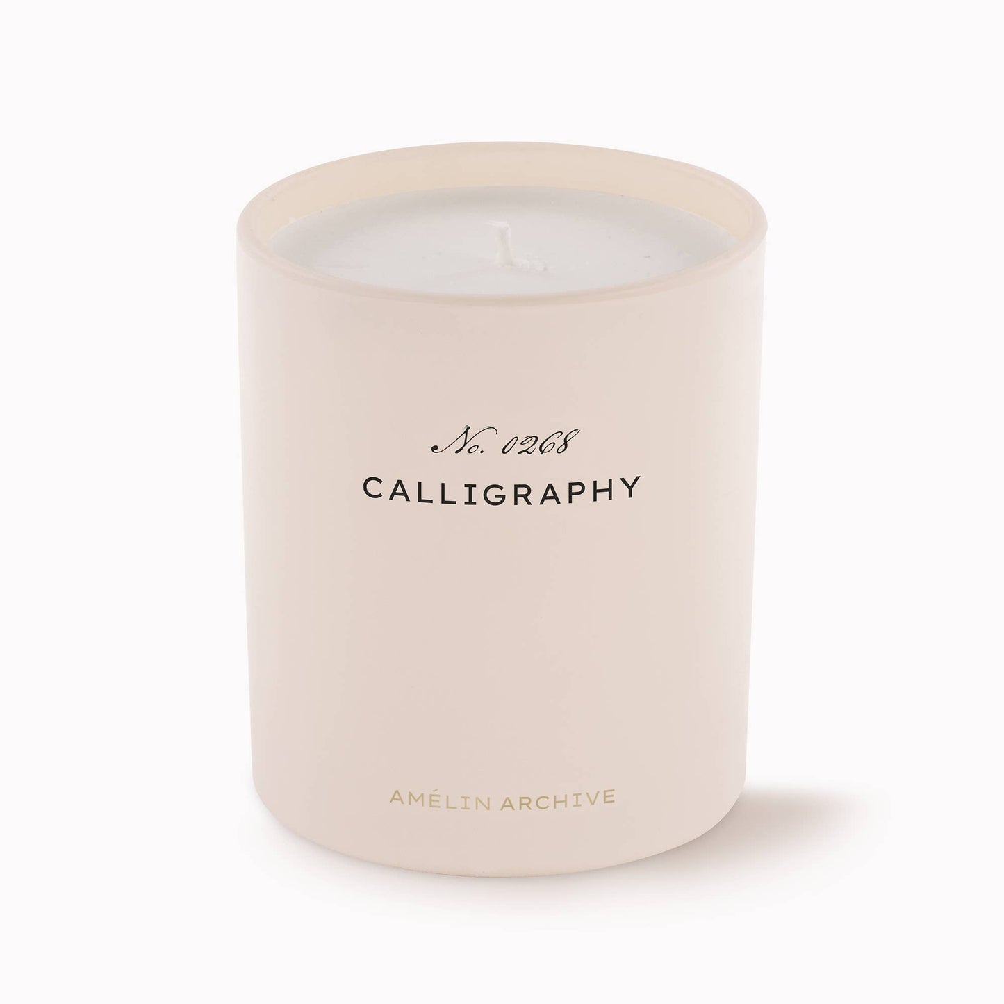 Cream glass Calligraphy Candle with vintage packaging, scented with green mandarin, violet, amber, and cedar.