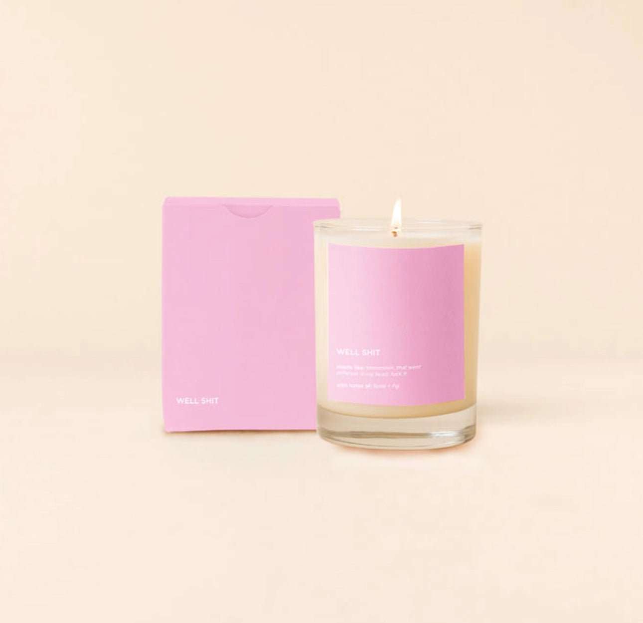 Candle Rocks Glass with pink label, "Well Shit," made of soy wax, cotton wick, 16oz, in can-shaped glass.
