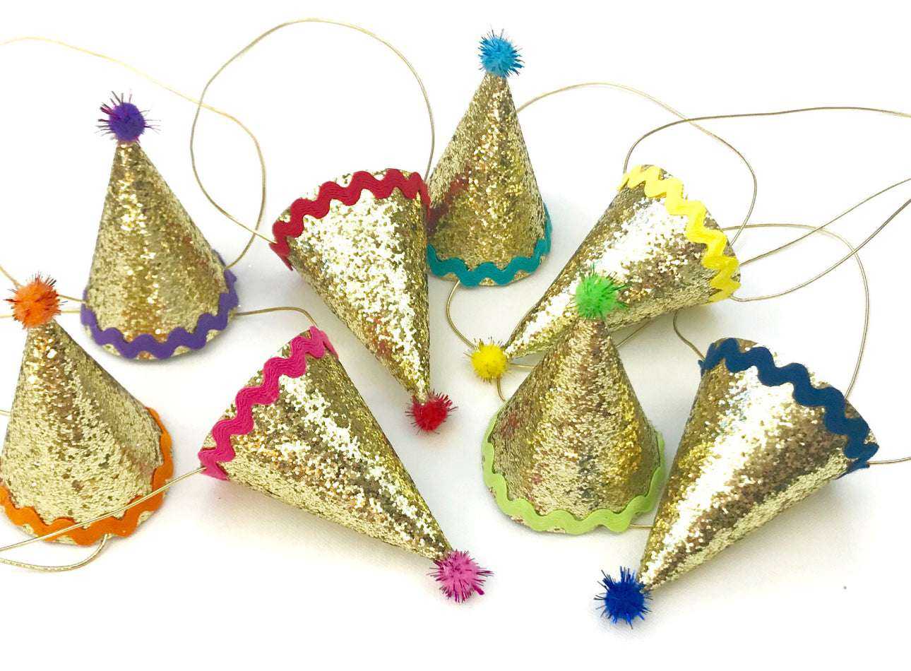 Celebration Box with glittery handmade fabric party hats in various colors.