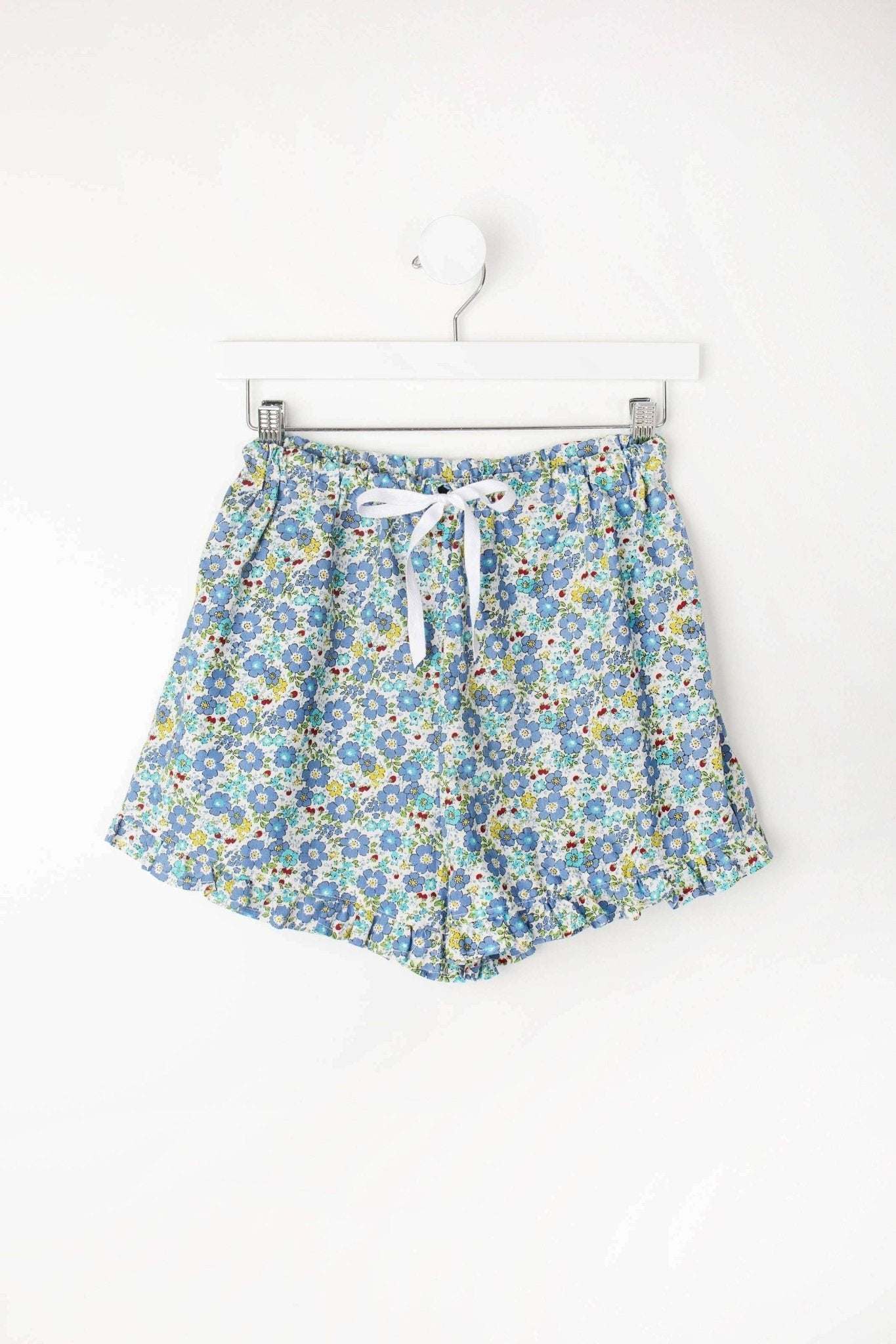 Charlotte Ruffle PJ Shorts with floral print and ruffle edges, 100% cotton, elastic waistband, and ribbon tie.