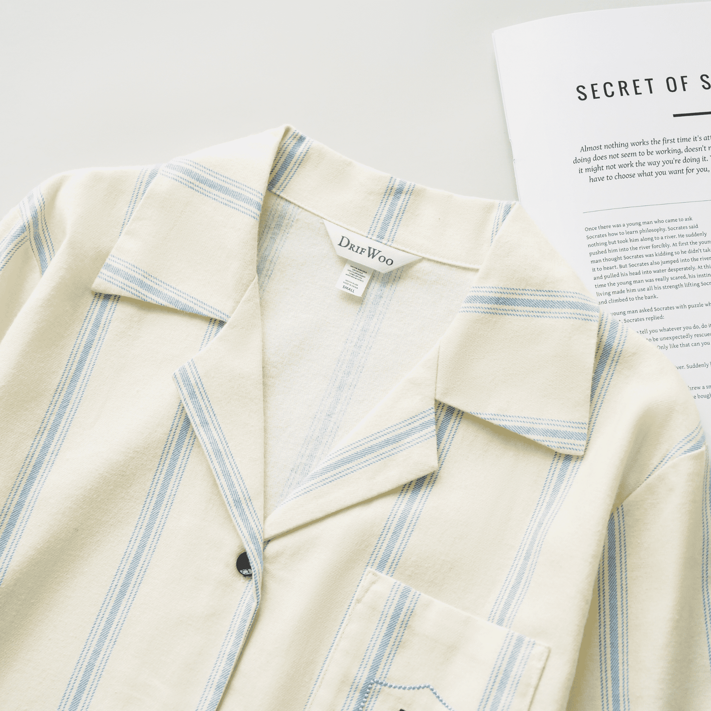 Cotton striped loungewear set with blue stripes on cream background, featuring playful embroidered cat details.