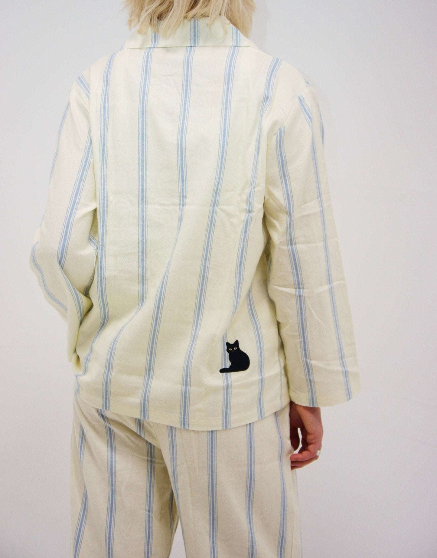 Cotton striped loungewear set with embroidered cat detail, featuring blue stripes on cream fabric.