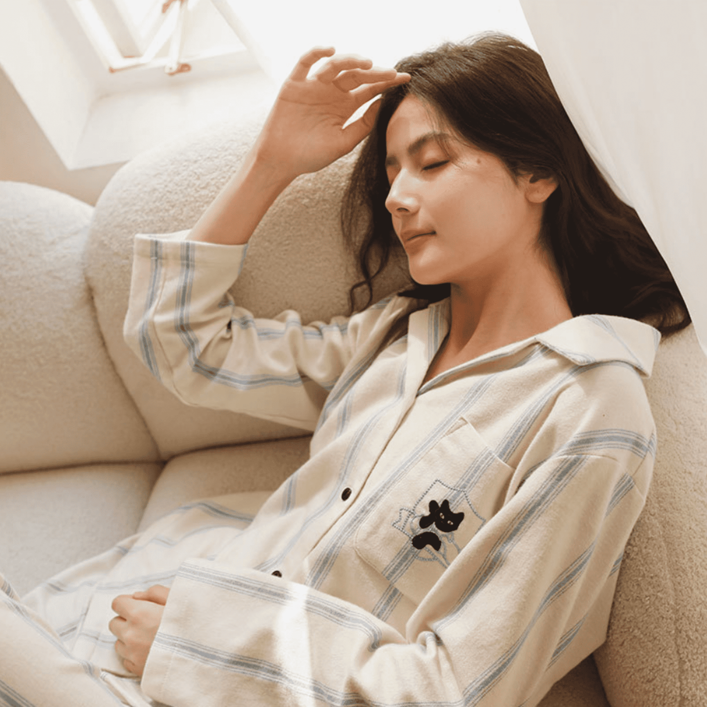 Cotton striped loungewear set with embroidered cat detail in blue stripes on cream background.