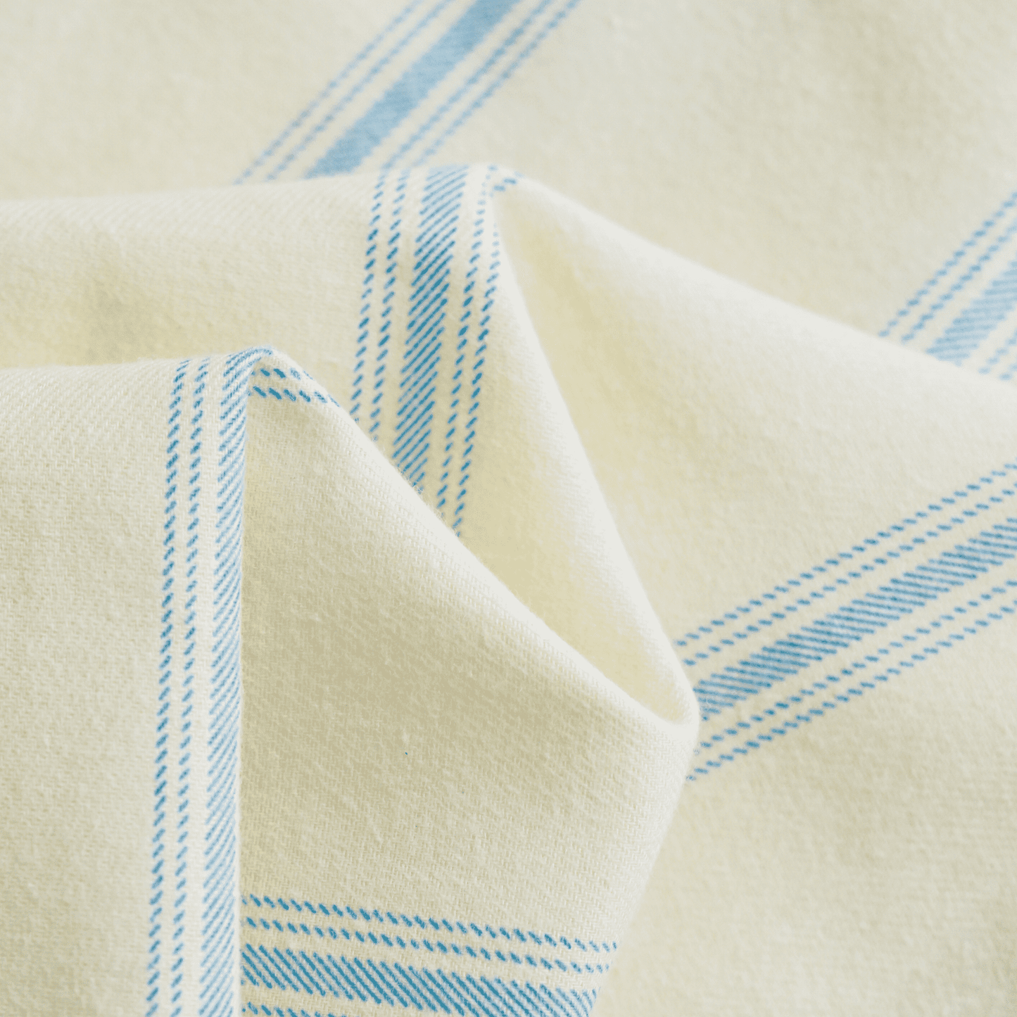 Cotton loungewear with blue stripes on cream fabric.