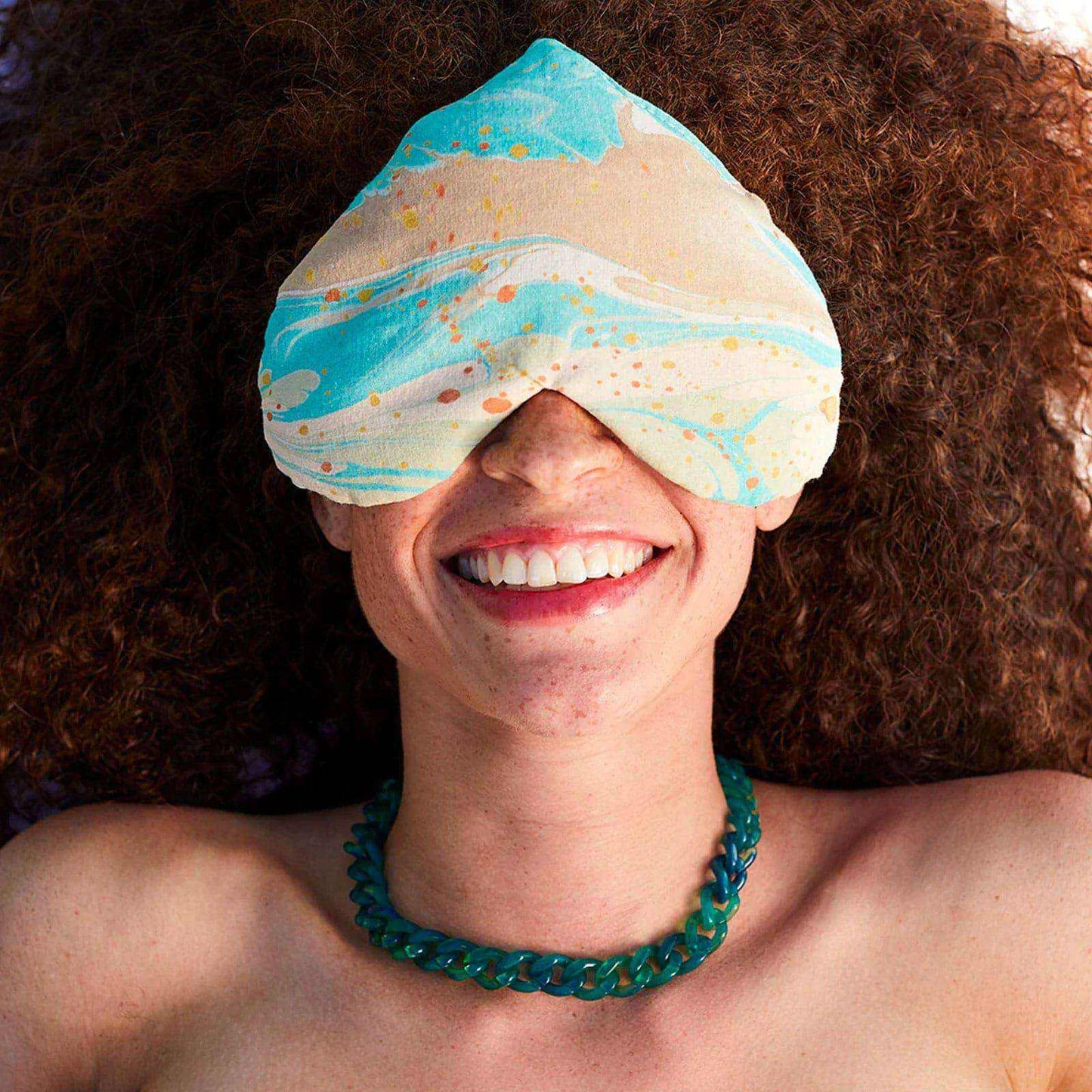 Heart-shaped Eye Love Pillow made of hand-marbled organic cotton with silk backing.