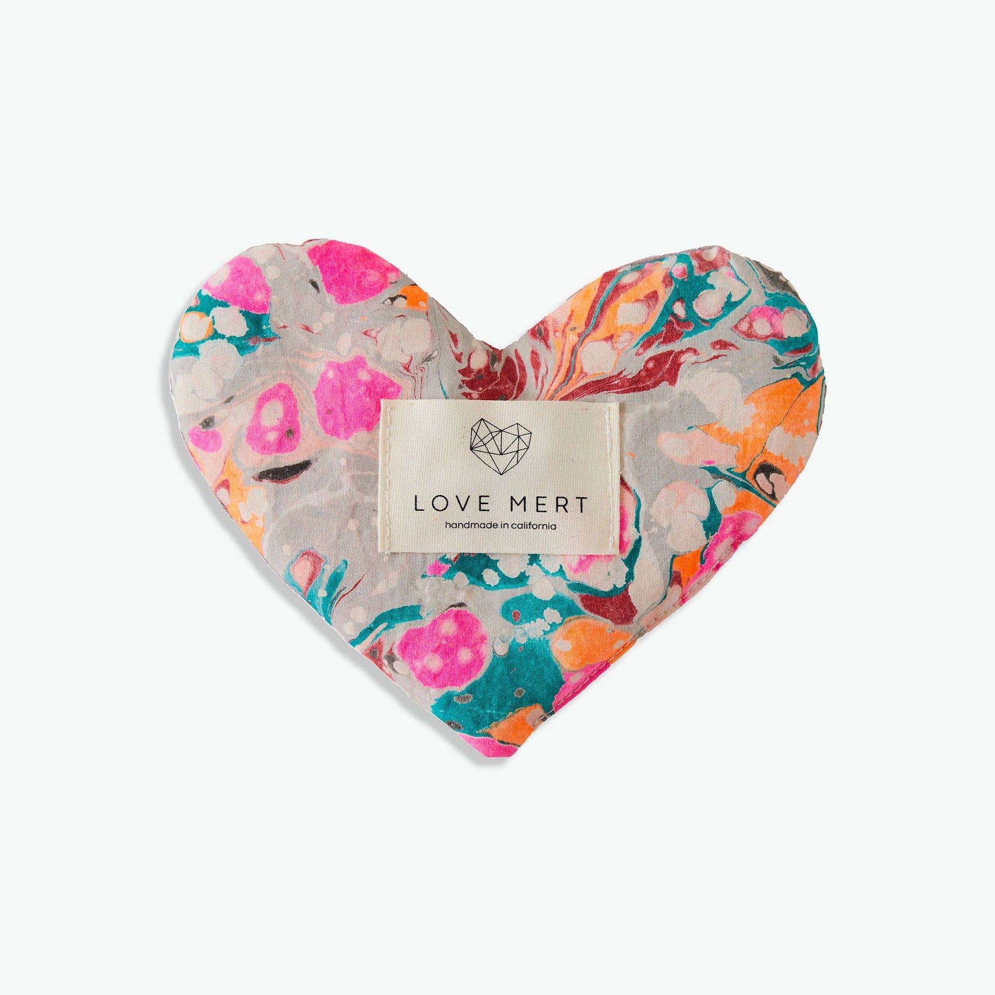 Heart-shaped Eye Love Pillow with hand-marbled organic cotton, raw silk backing, flaxseed and lavender filling.