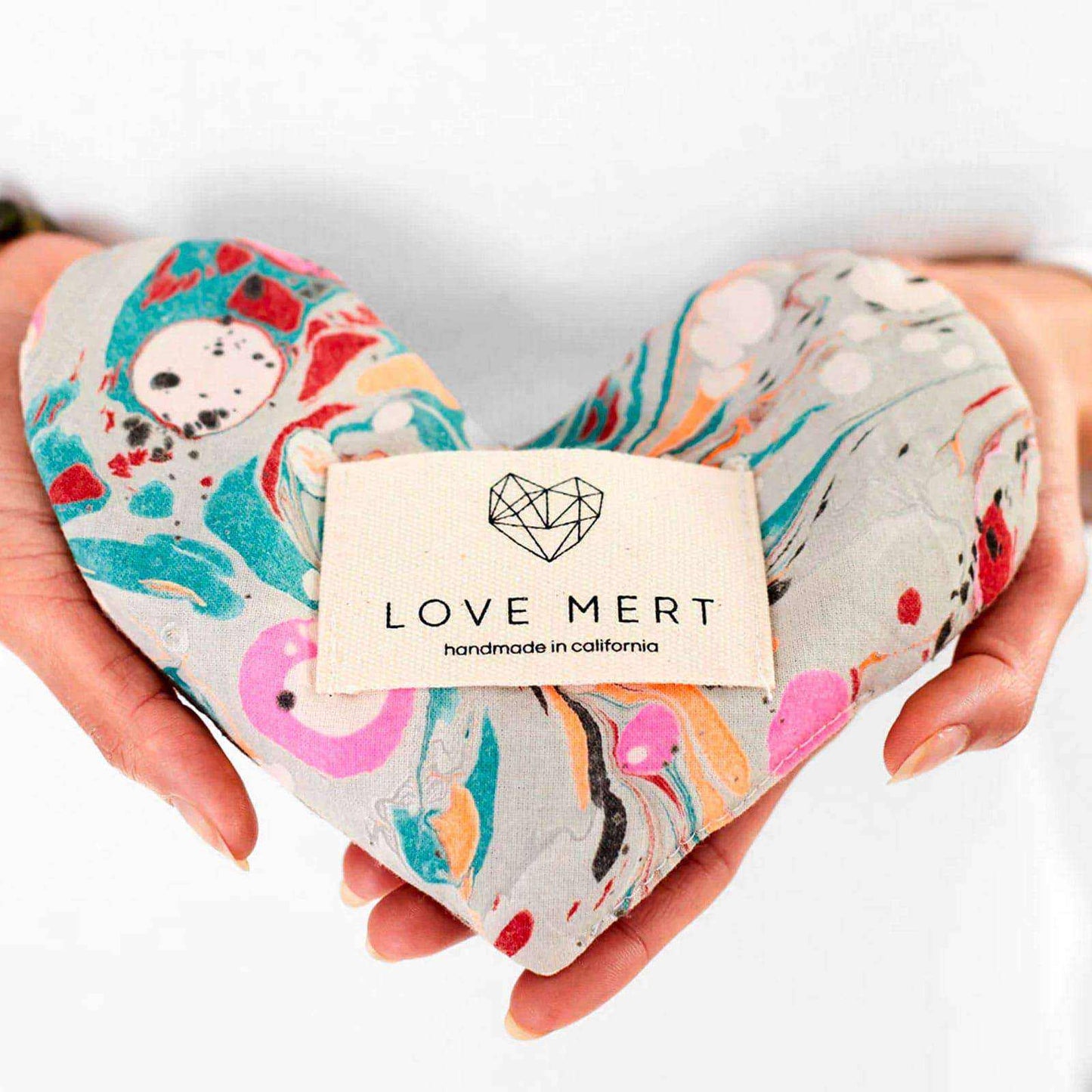 Heart-shaped Eye Love Pillow, hand-marbled organic cotton, raw silk backing, filled with organic flaxseed and lavender.