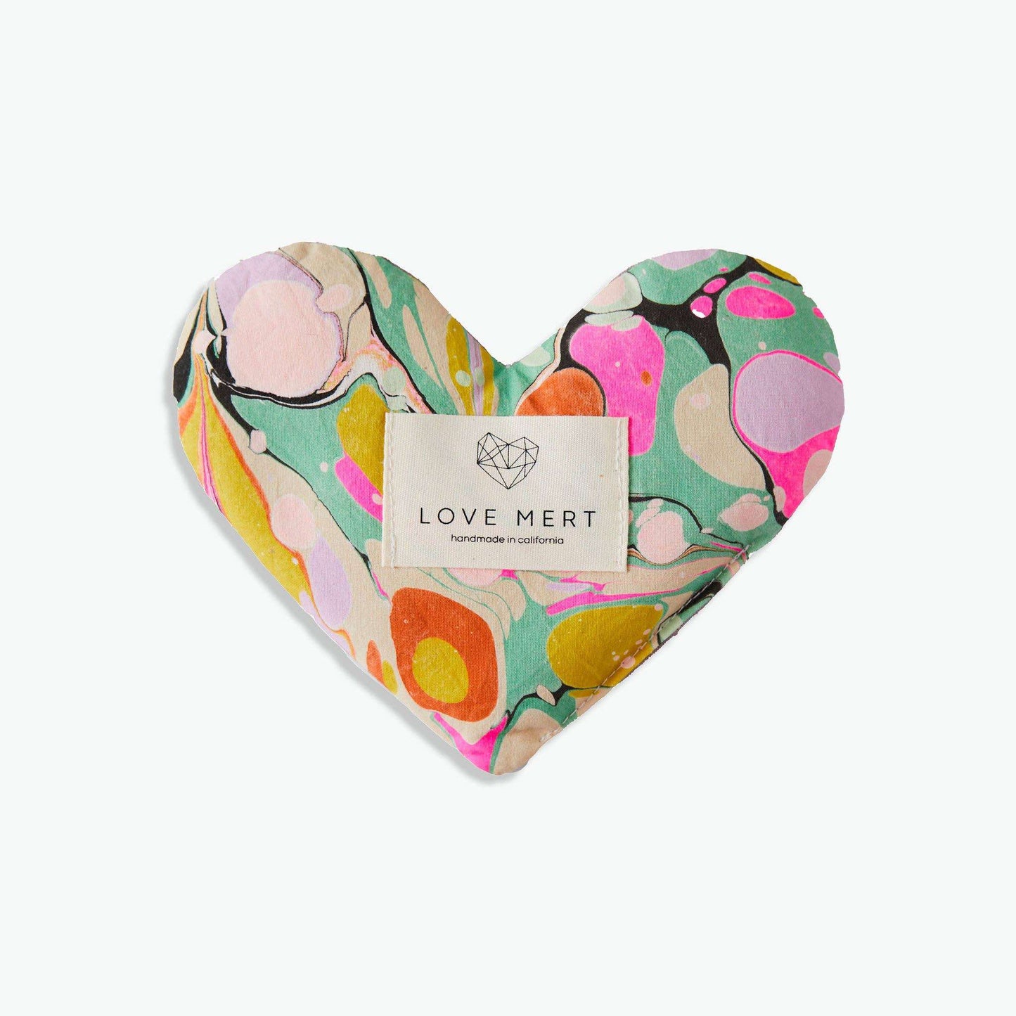 Heart-shaped Eye Love Pillow with colorful marbled organic cotton and raw silk backing.