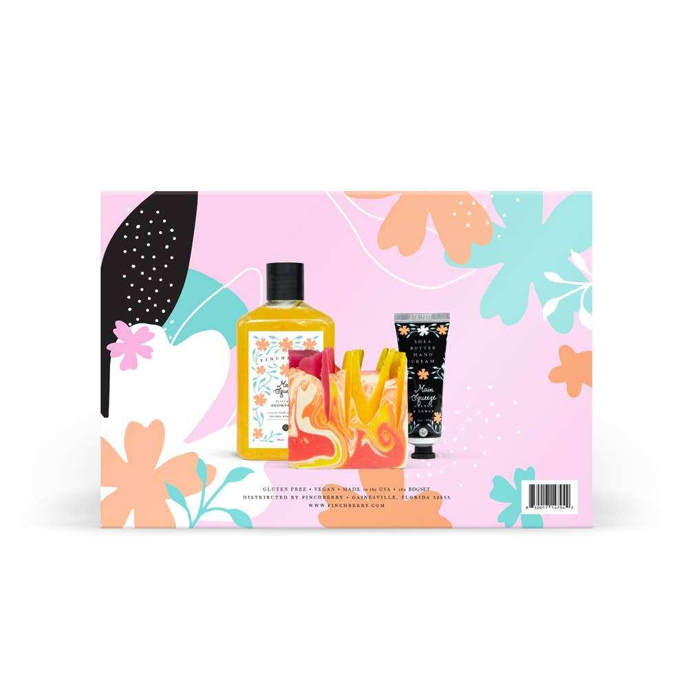 Finchberry Happy Birthday Bath & Body Gift Set with soap, shower gel, and hand cream against colorful floral background.