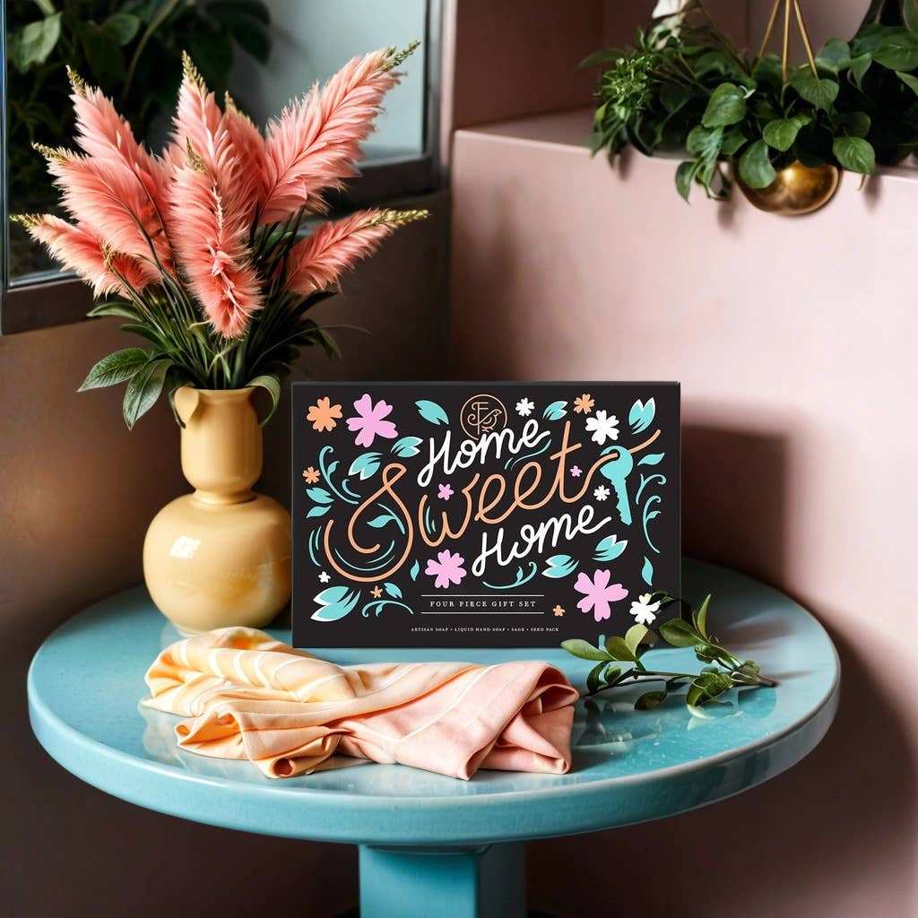 Home Sweet Home bath and body gift set on a glass table with plants and decor.