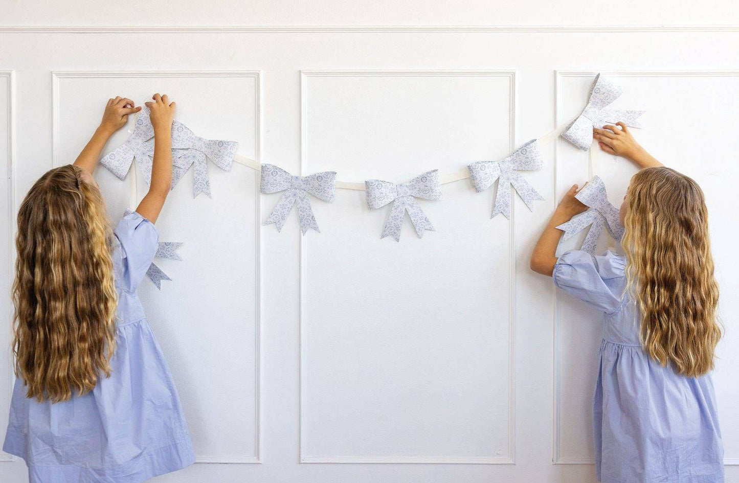 Floral Bow Banner with delicate flowers and cute bow design hanging on a wall, suitable for spring events.