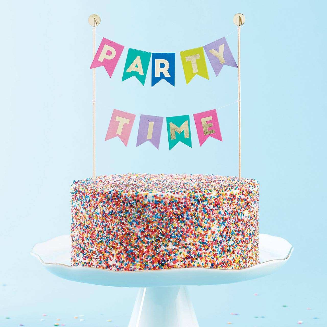 Garland Cake Topper on colorful sprinkle cake.