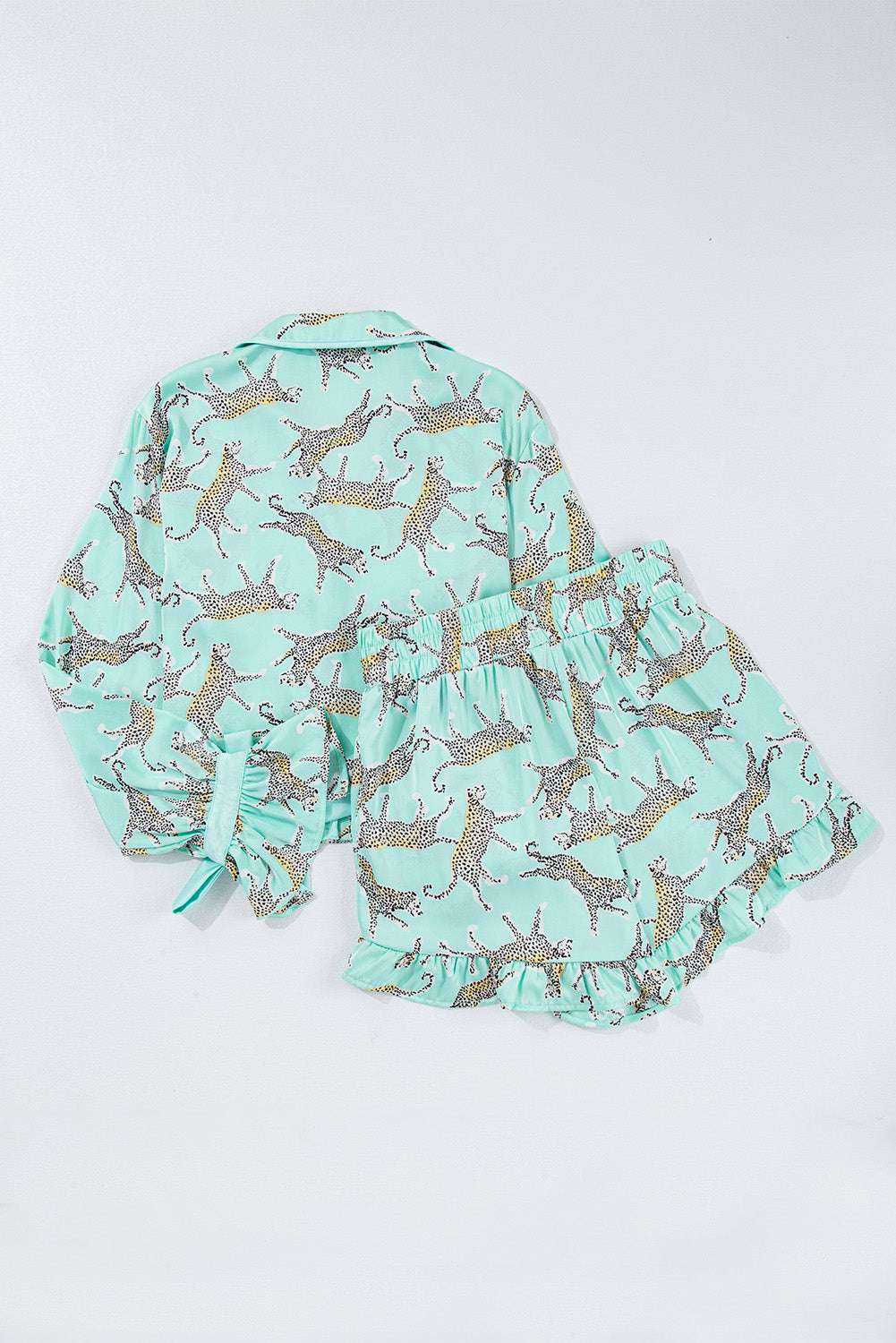 Green leopard satin ruffle pajama short set with button-front cropped top and high-waisted shorts.