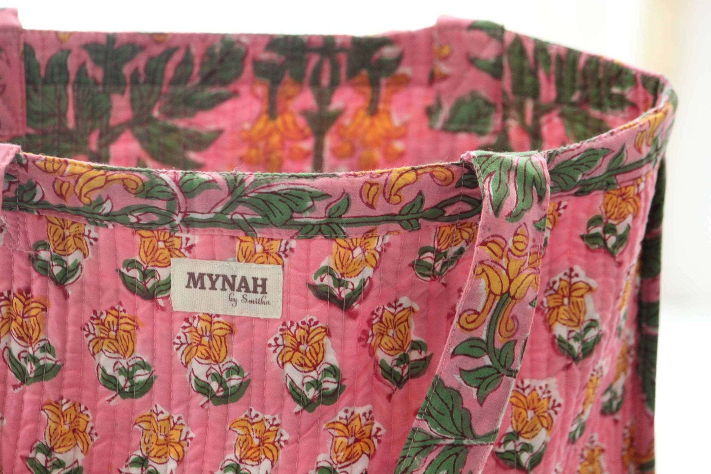 Handmade Bubblegum Forest floral print reversible tote bag with quilted fabric and coconut button closure.