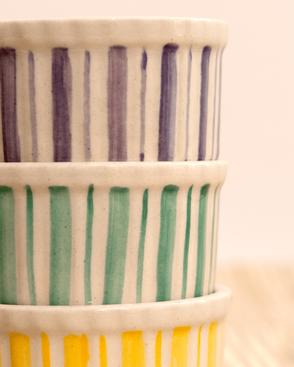 Handmade ceramic stripe bowls in gray, green, and yellow; set of 3.