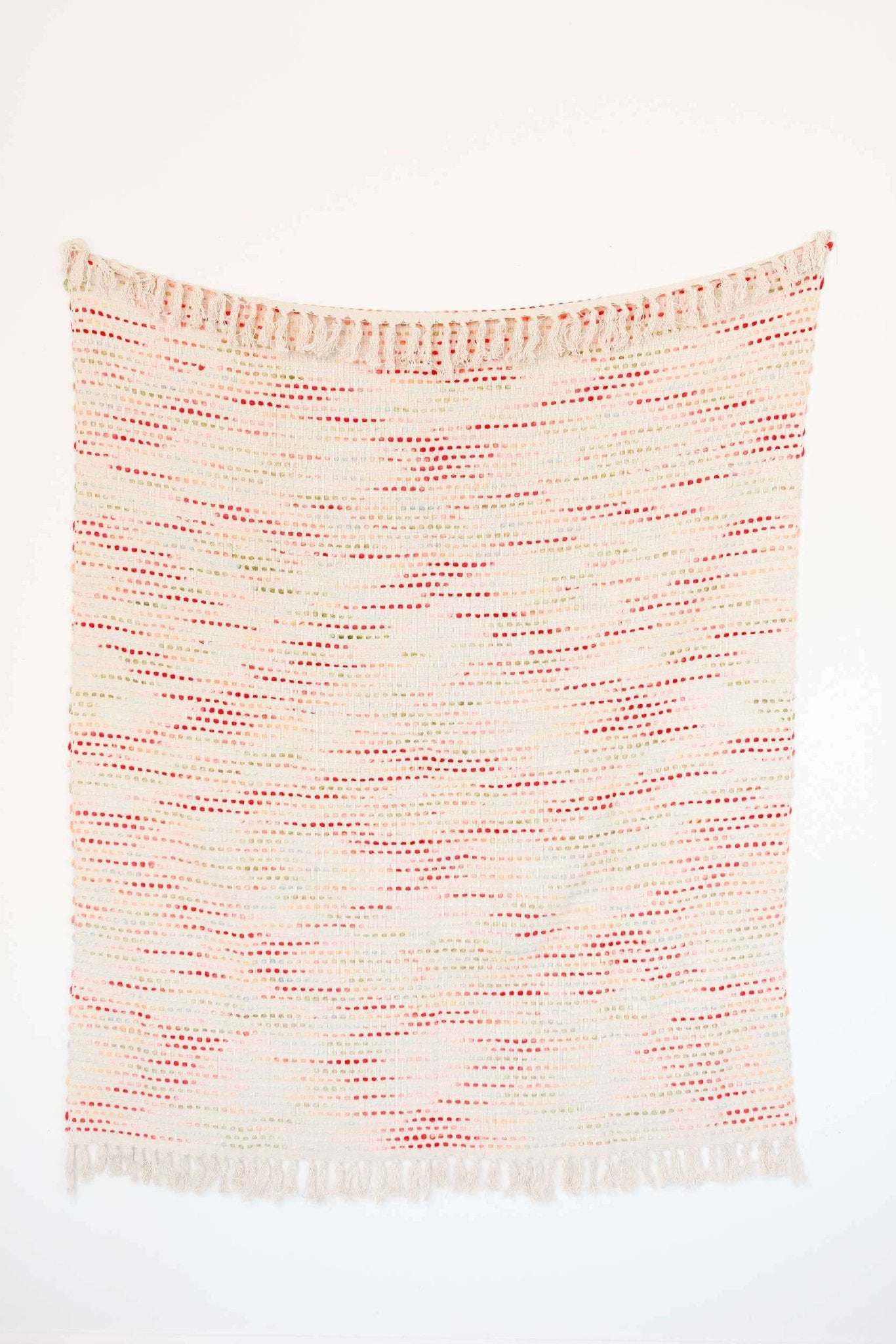 Handwoven Confetti Throw with colorful design and knotted fringe ends.