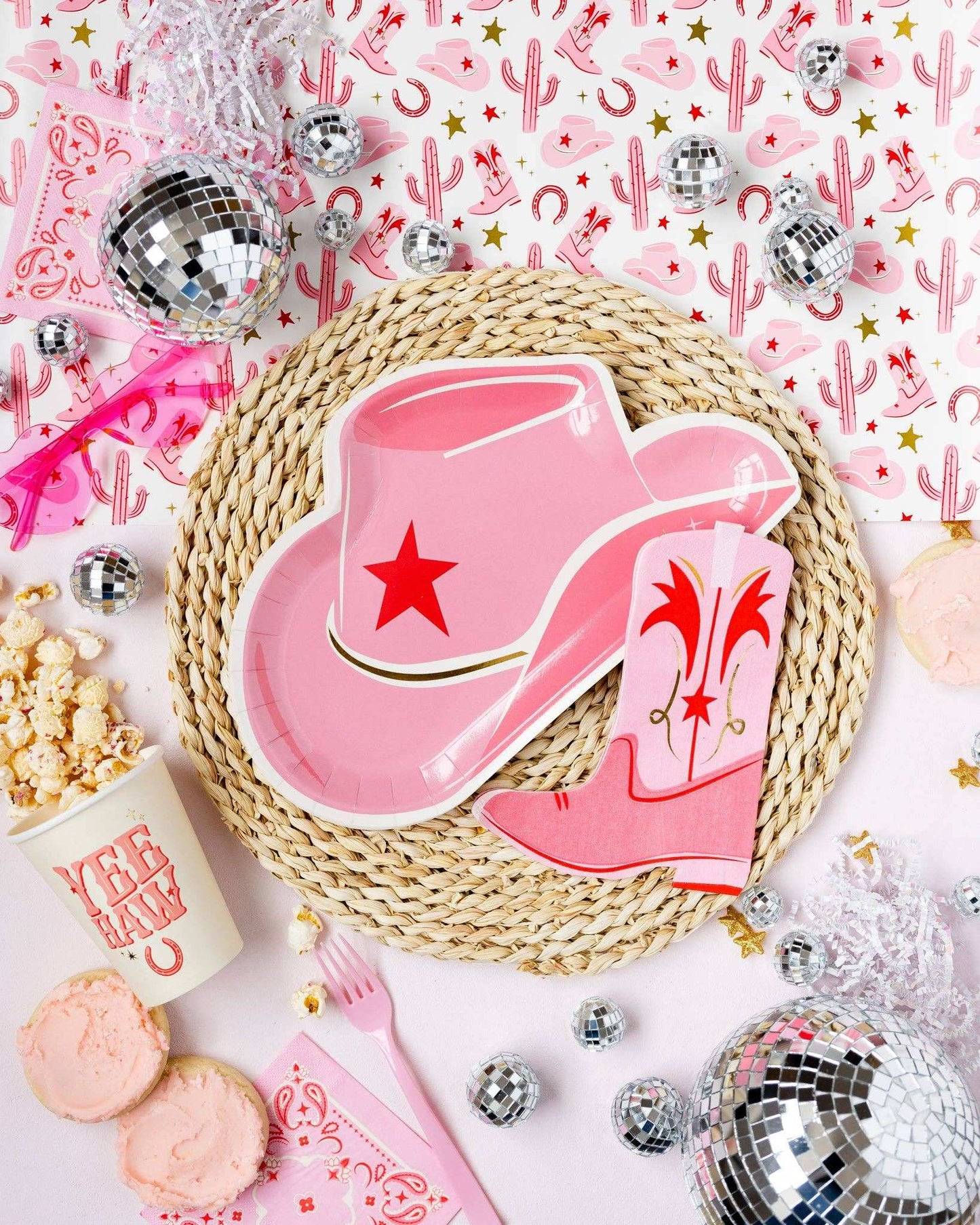 Pink cowgirl hat shaped paper plate with gold foil accents for Wild West themed parties.