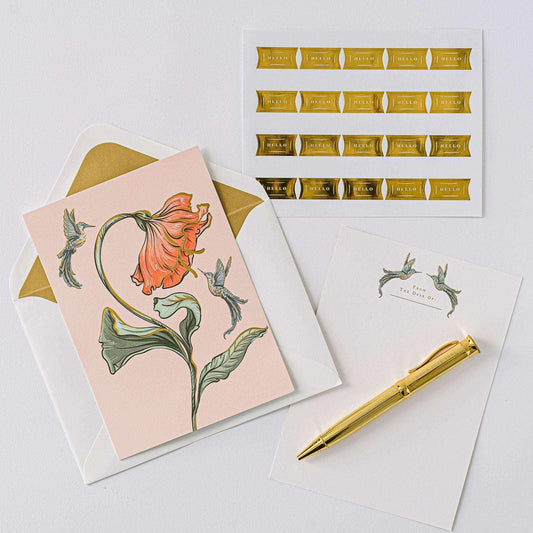 Hummingbird Luxury Stationery Set with gold foil-stamped writing sheets, metallic-lined envelopes, sealing stickers, and a gold ball-point pen.