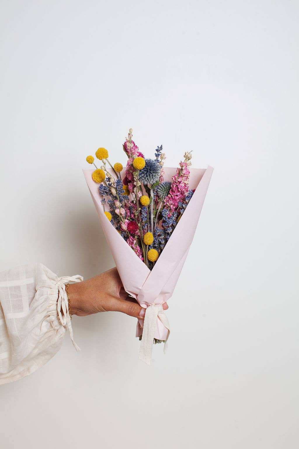 Idlewild Floral Co. bright small field bouquet with fuchsia, yellow, blue florals and greenery.