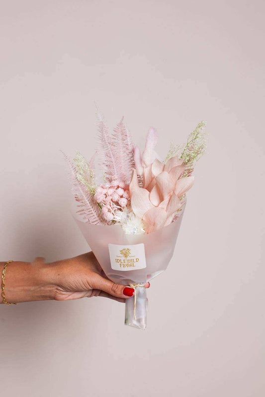 Idlewild Floral Co. Mini Lark Bouquet; blush dried flowers in hand, ideal for Valentine's Day decor.