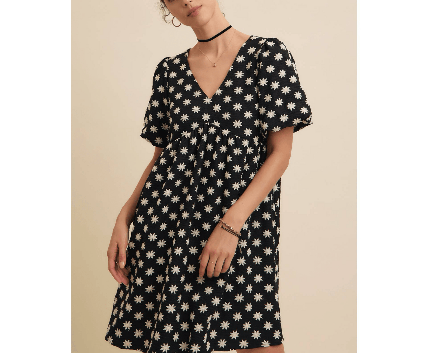 Embroidered mini dress with V-neckline, puff sleeves, and side pockets.