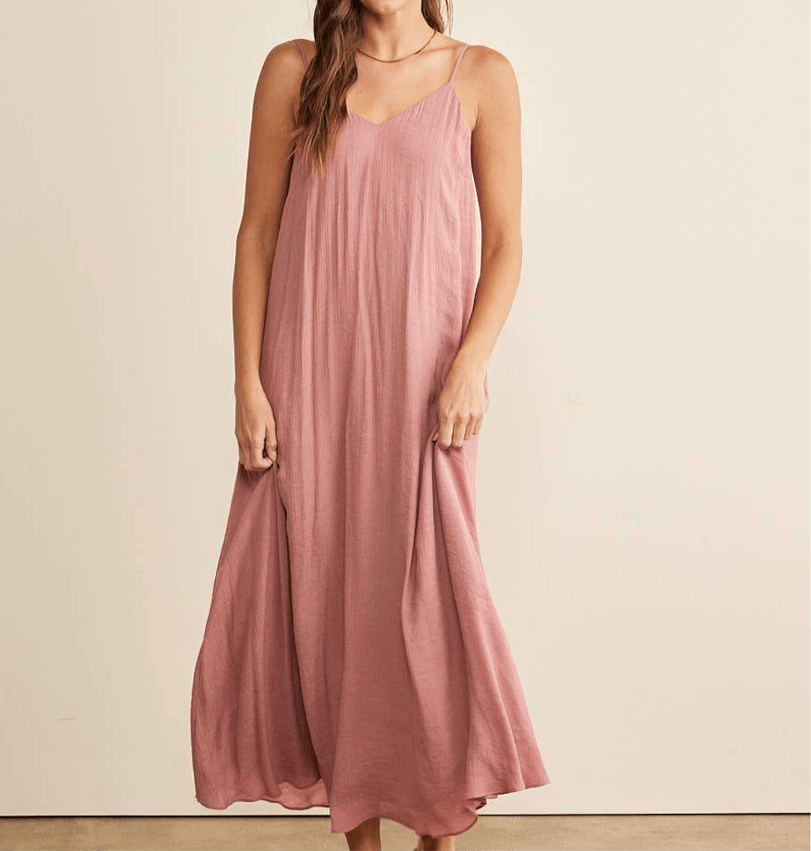 Flowy maxi dress with V-neck and adjustable spaghetti straps.