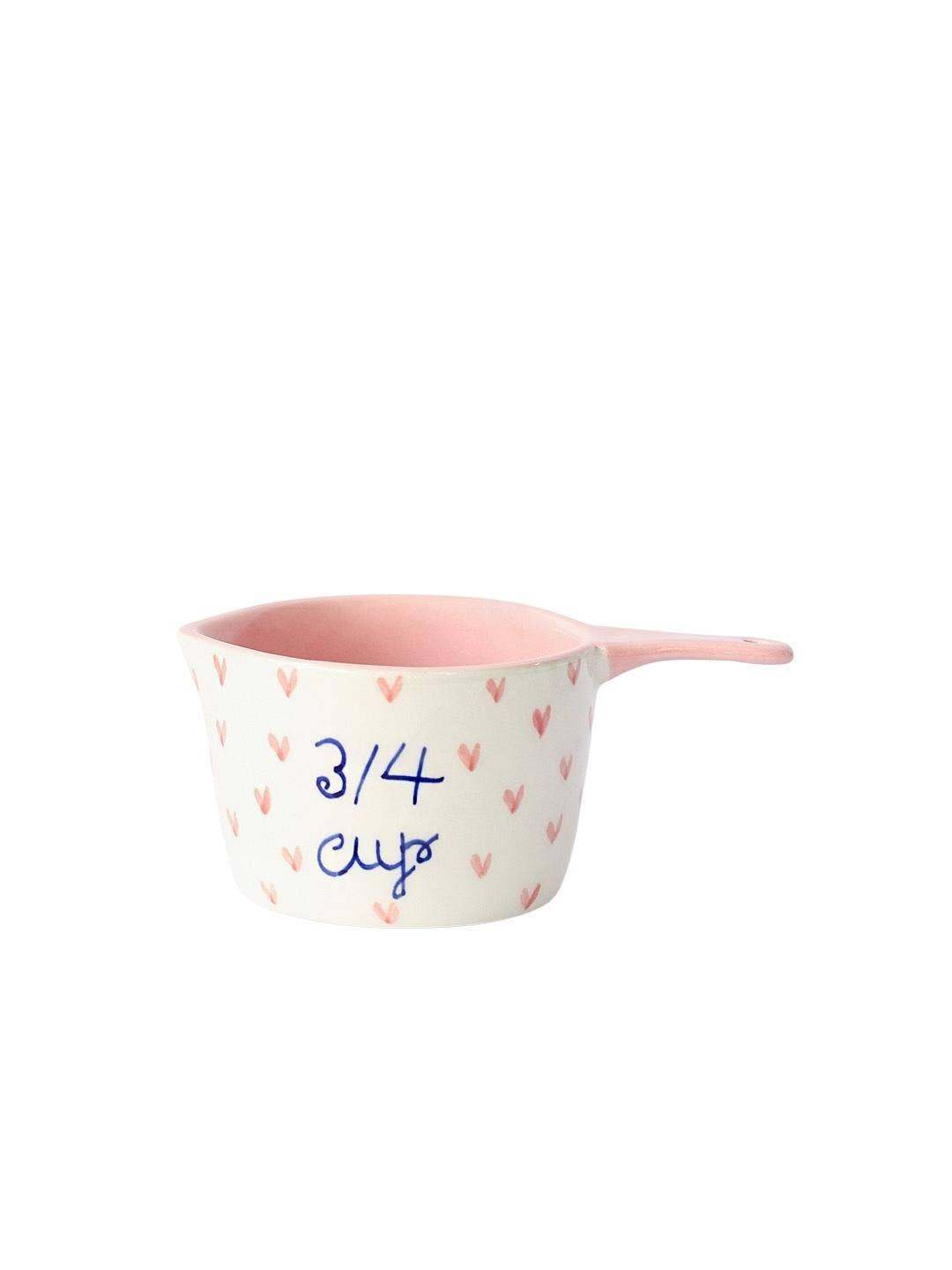 Handpainted ceramic measuring cup featuring little hearts design.