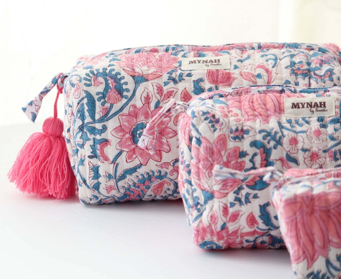 Lotus blooms floral travel bag with hand block print, waterproof lining, and pink tassel.