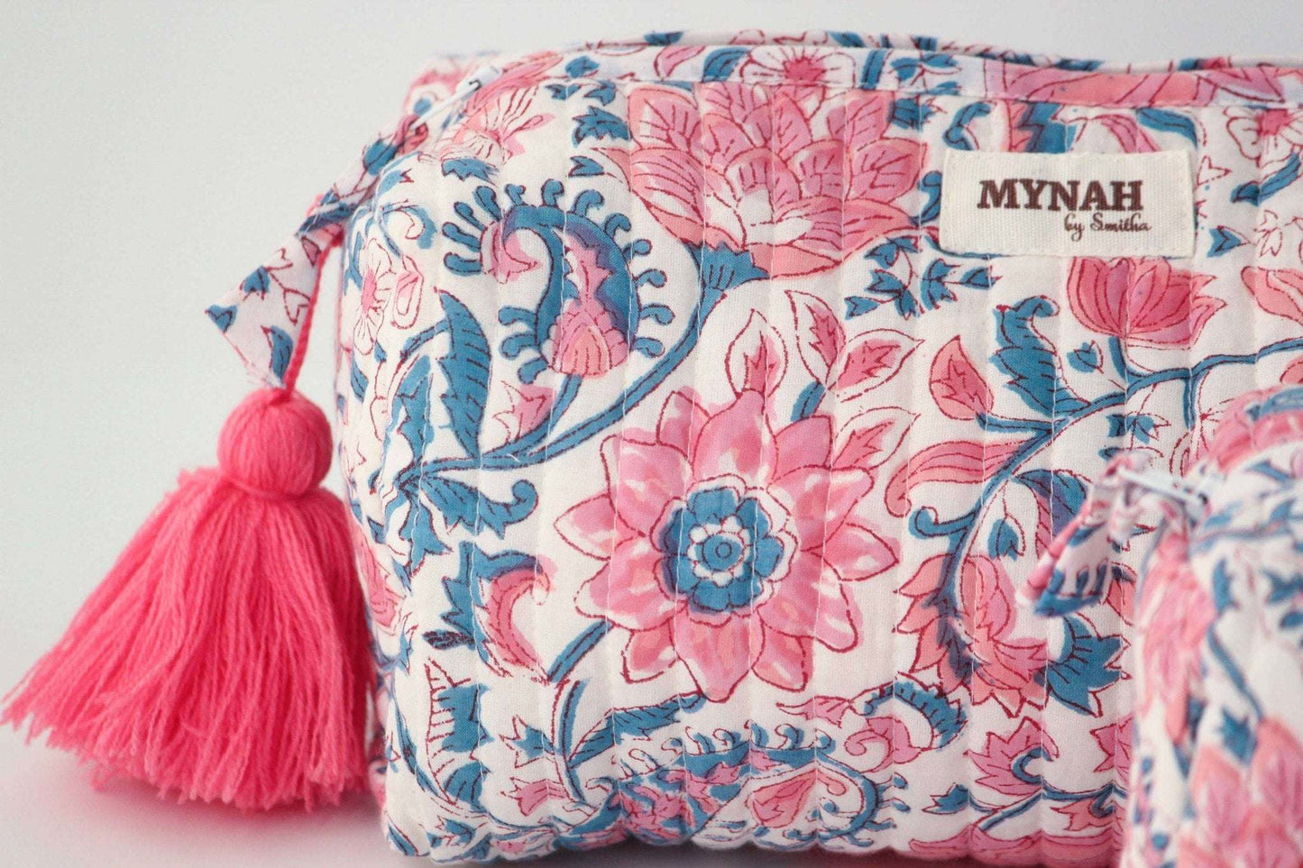 Lotus blooms floral quilted travel bag with hand block print and pink tassel.