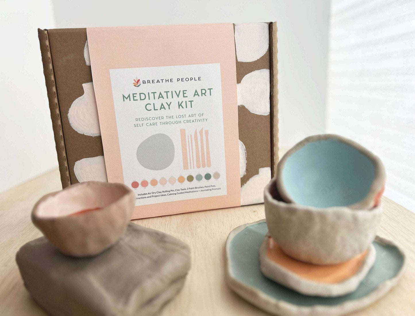 Meditative Art Clay Kit with handcrafted clay bowls and packaging, featuring tools and paints for creative self-expression and connection.