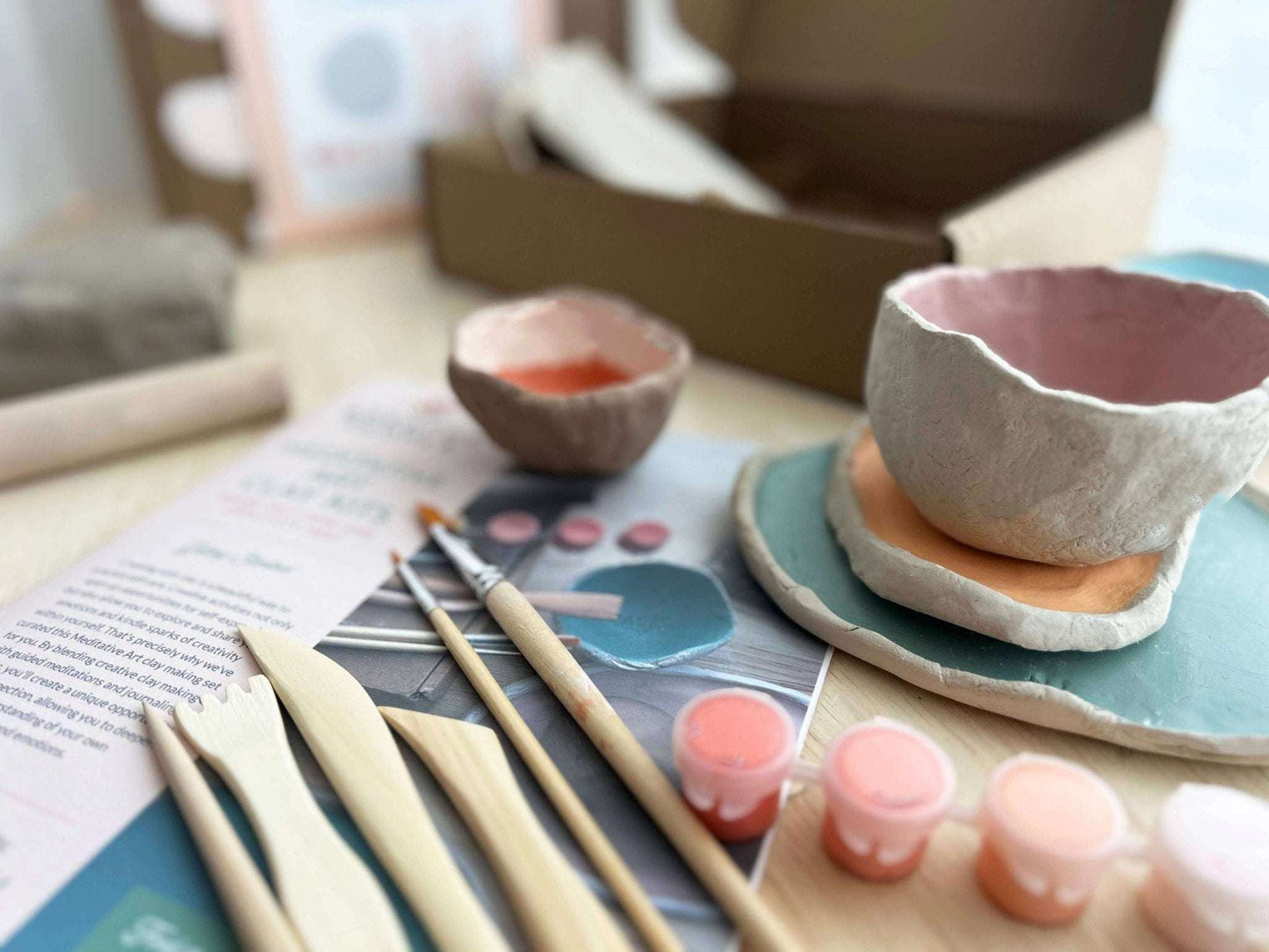 Meditative Art Clay Kit with tools, paint, and project instructions on a table.