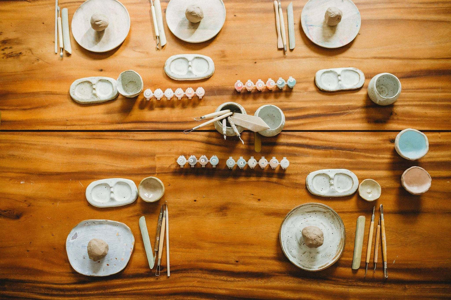 Meditative Art Clay Kit with tools, air dry clay, acrylic paints, and brushes on a wooden table.