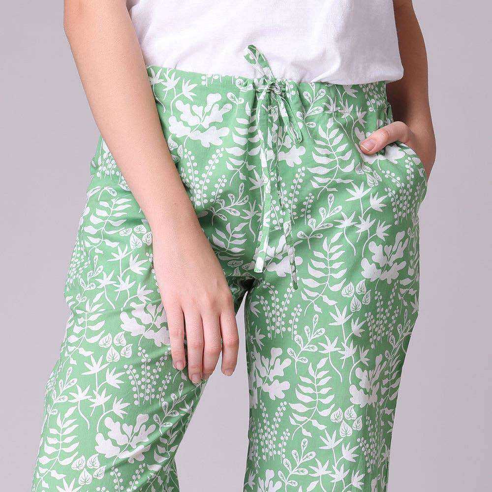 Miya Pant in a bag featuring hand screen-printed green fern design on lightweight cotton fabric with drawstring, elastic waist, and pockets.