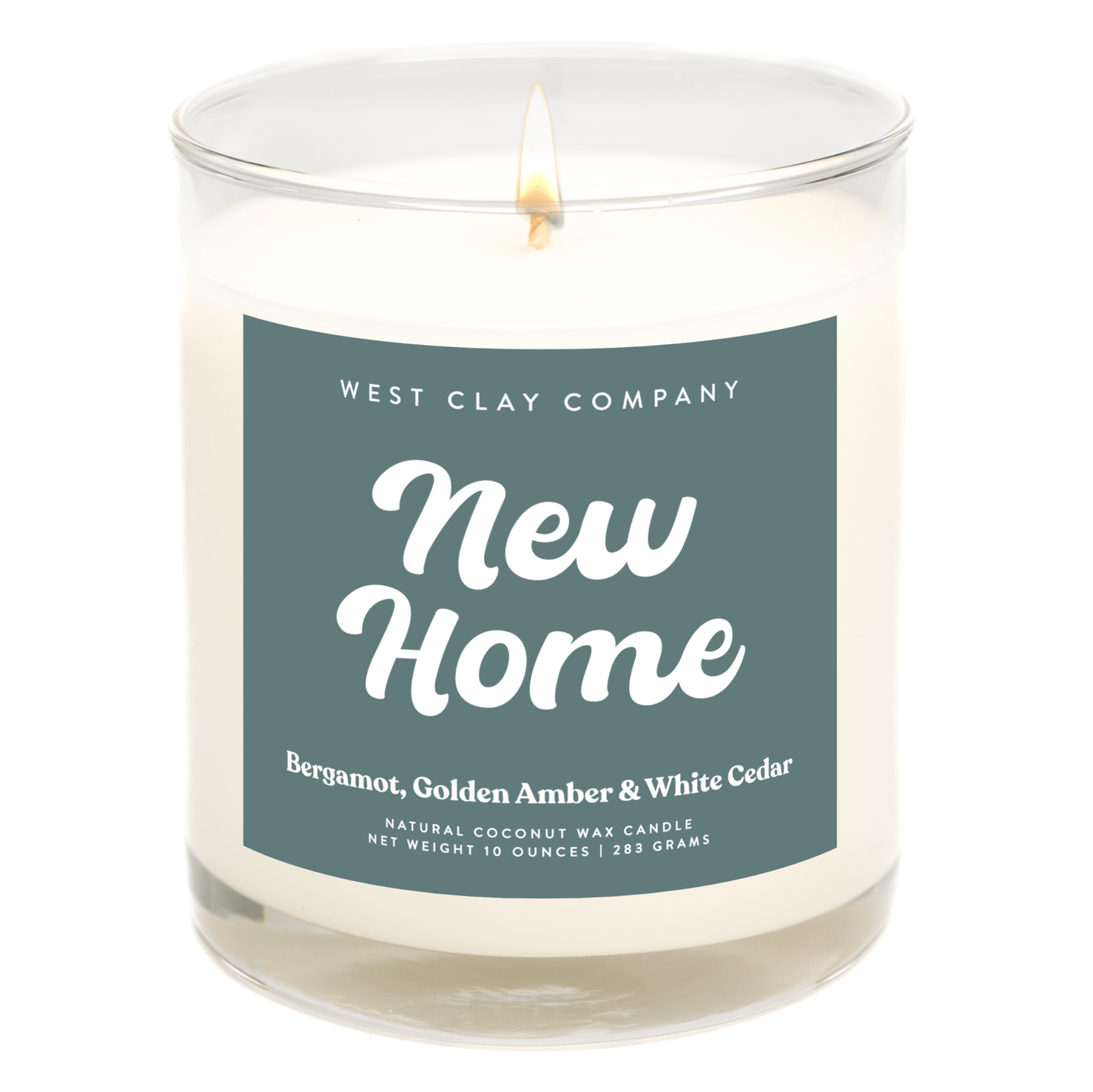 New Home Candle with Bergamot, Amber, and White Cedar scent in a glass jar.