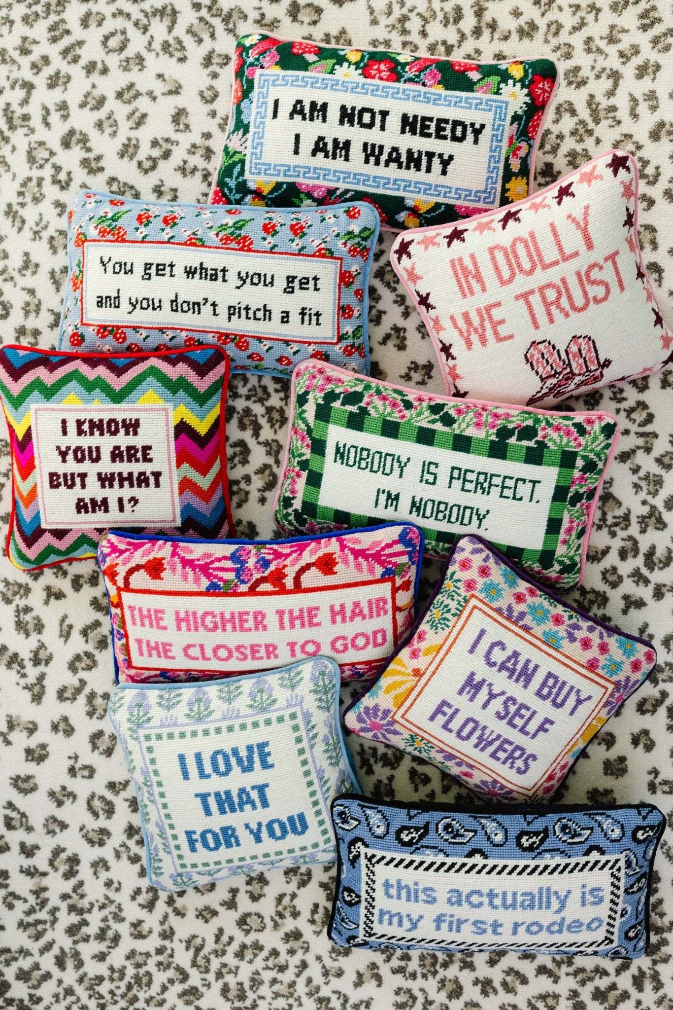Chic needlepoint pillows with snarky phrases; decorative and vibrant with luxe velvet backing.