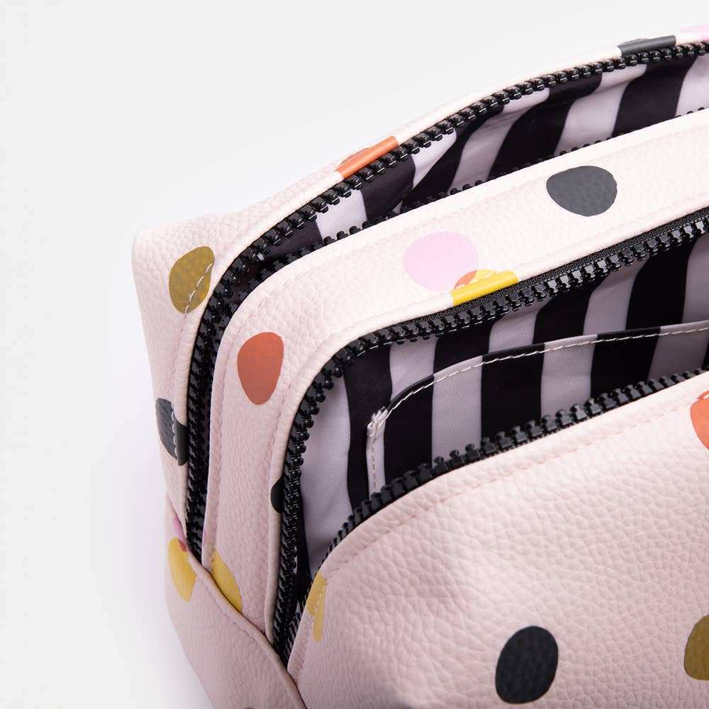 Pale pink dotty large travel washbag with gold zip and handle.