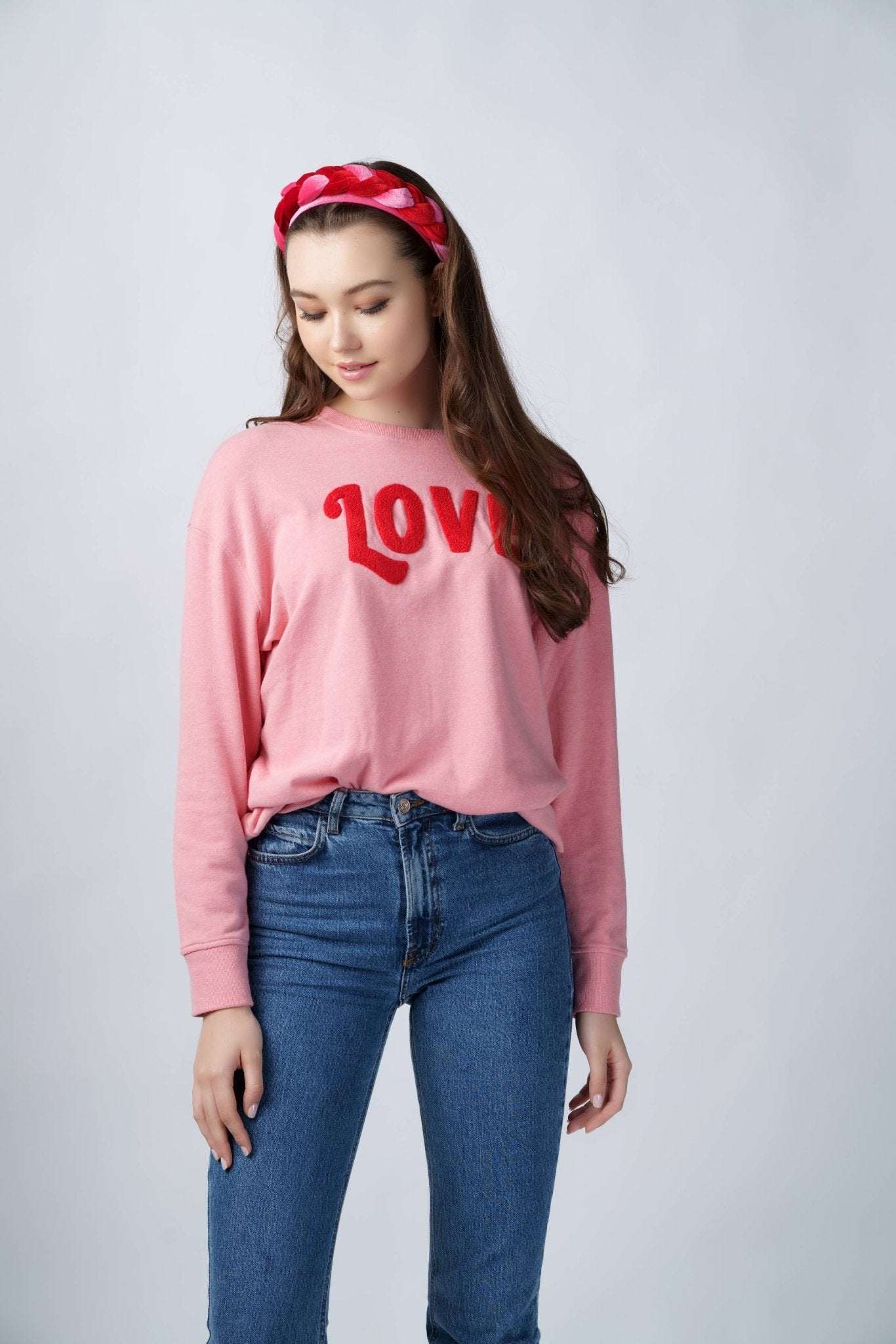 Pink “LOVE" Sweatshirt in soft cotton blend.