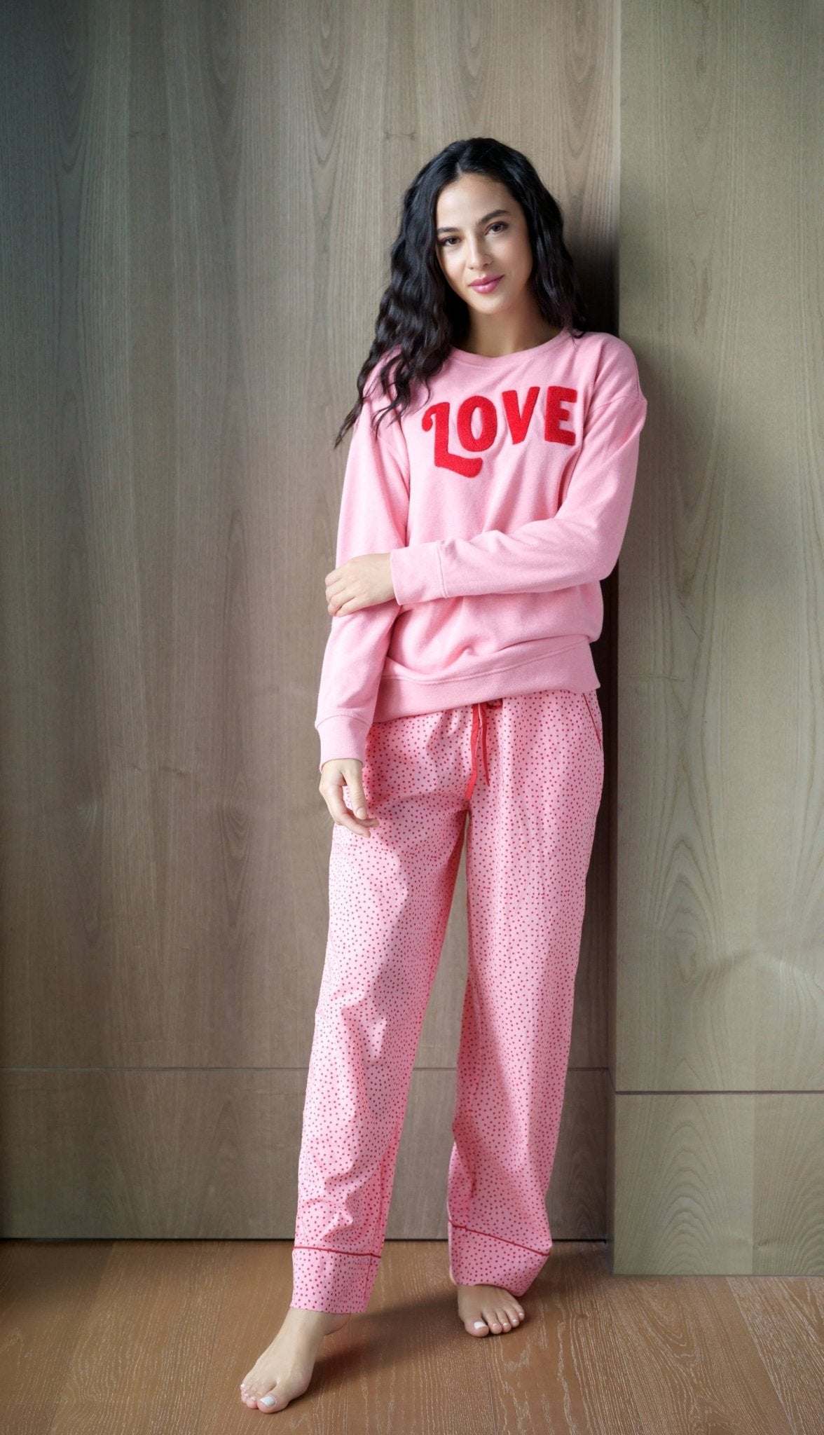 Pink "LOVE" sweatshirt made of cotton, polyester, and rayon.