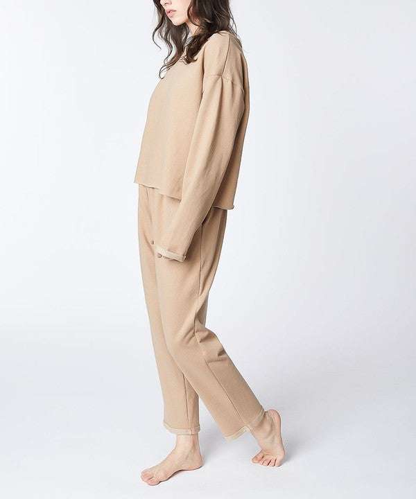 Recycled cotton lounge set in beige, featuring a loose fit with reverse stitch and raw edge accents.
