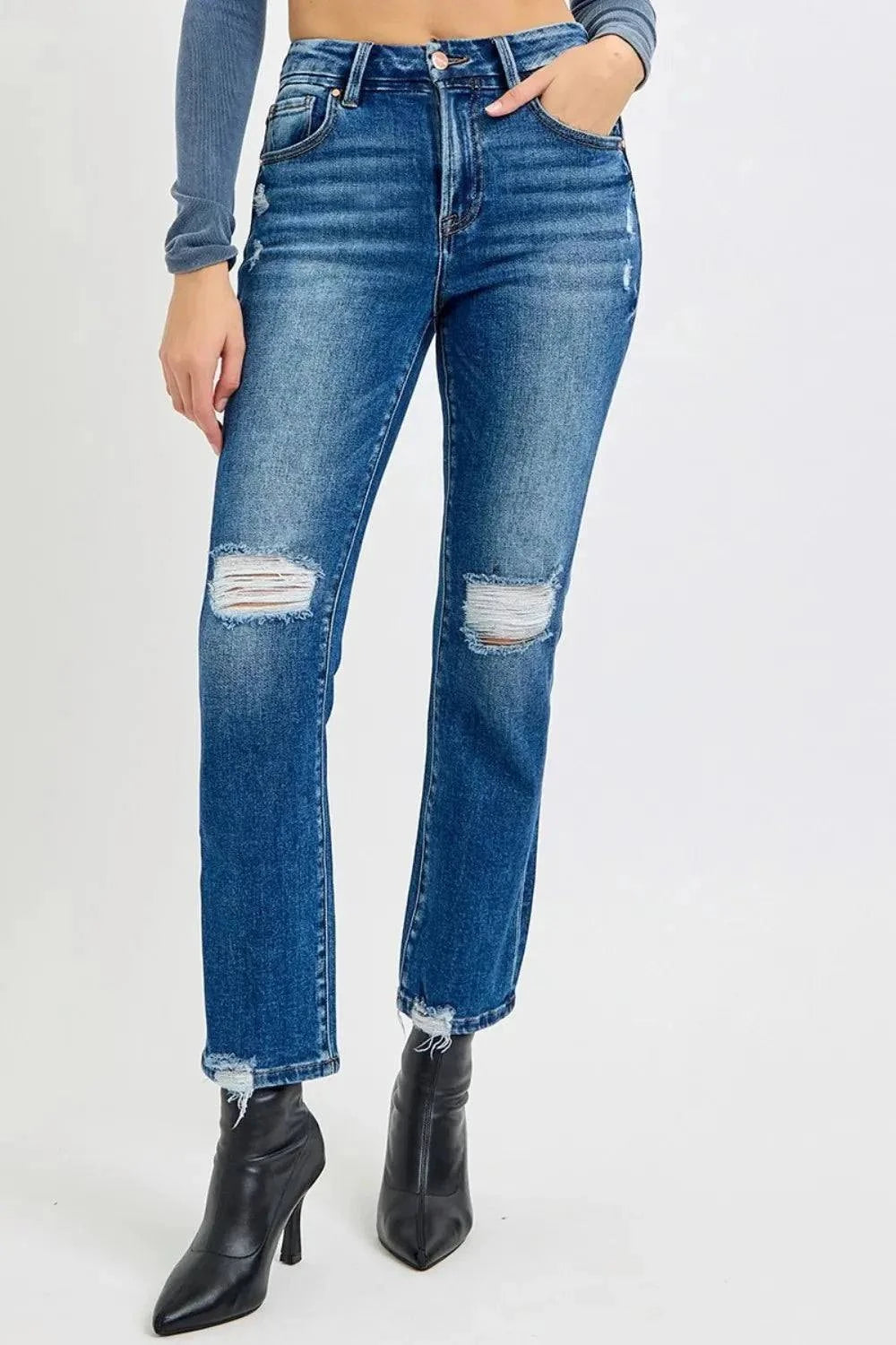 High Rise Distressed Crop Jeans with raw hem and pocket detail.