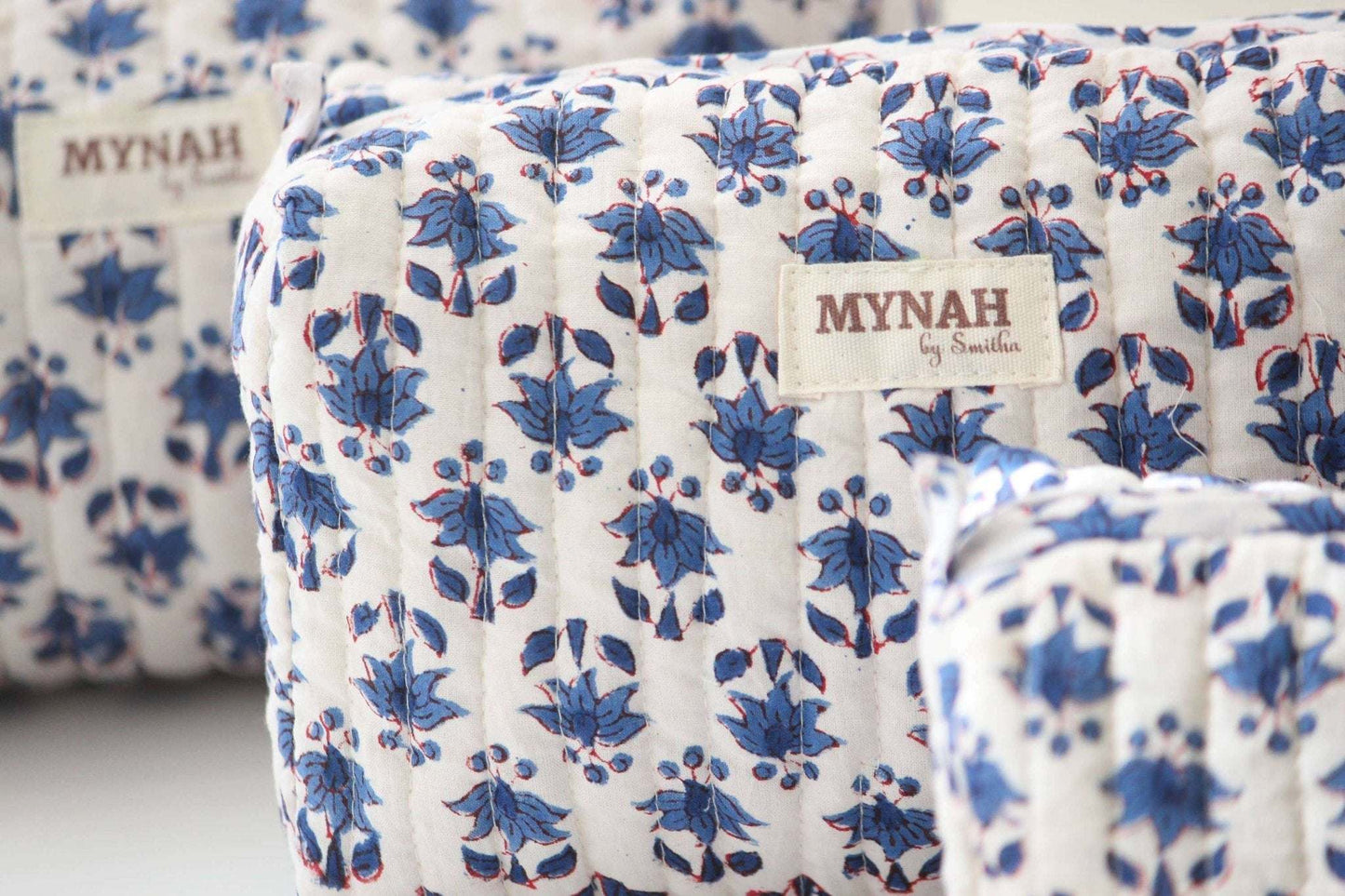 Set of 3 blue bonnet floral print travel bags with waterproof lining.