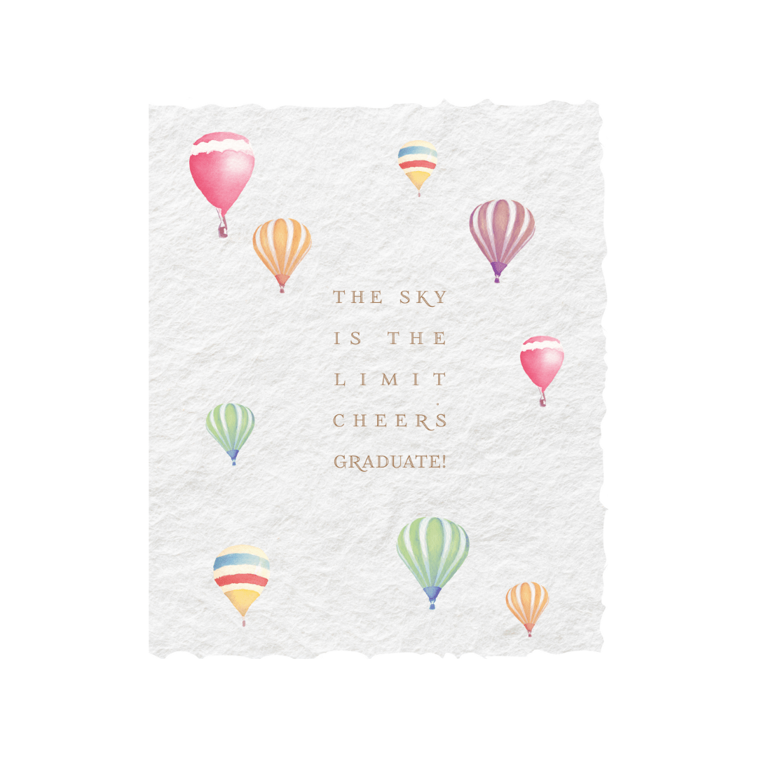 Graduation card with "Sky is the limit. Cheers Graduate" on deckled edge paper, featuring colorful balloons and gold ink.