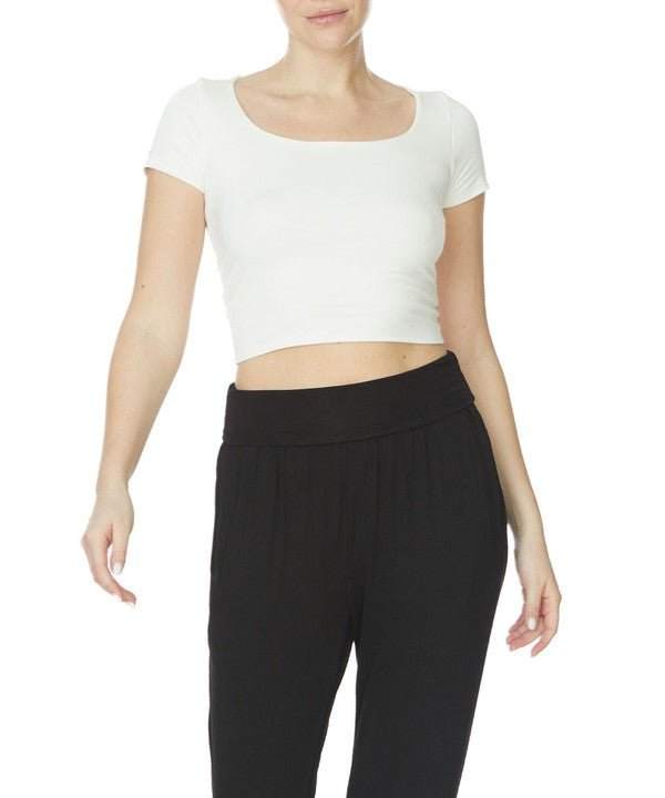 Studio Ko Bamboo Crop Cap Sleeve Top with U-neckline and black pants.